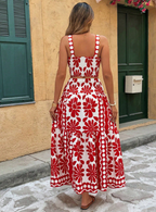 Back view of the Yolanda Jumpsuit Maxi Dress Retro-Print Sleeveless Wide-Leg in red and white, featuring thin straps, a fitted back, bold retro floral print, and flowing wide legs. Designed by Charlier Paris.