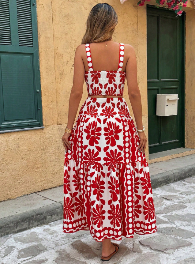 Back view of the Yolanda Jumpsuit Maxi Dress Retro-Print Sleeveless Wide-Leg in red and white, featuring thin straps, a fitted back, bold retro floral print, and flowing wide legs. Designed by Charlier Paris.