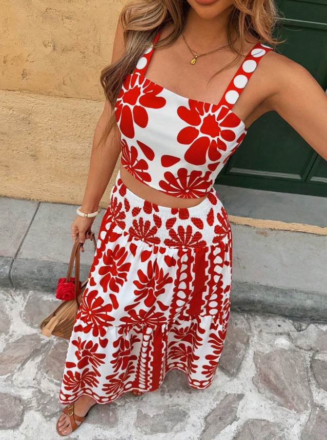 Close-up detail view of the Yolanda Jumpsuit Maxi Dress Retro-Print Sleeveless Wide-Leg in red and white, highlighting the thin straps, fitted bodice, and bold contrasting retro floral print. Designed by Charlier Paris.