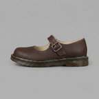 Side view of the Zayna Mary-Jane Flats Block Heels with Buckle Strap in Brown showcasing a smooth faux leather upper, secure buckle strap, supportive low block heel, and comfortable fit by Bella Hudson.